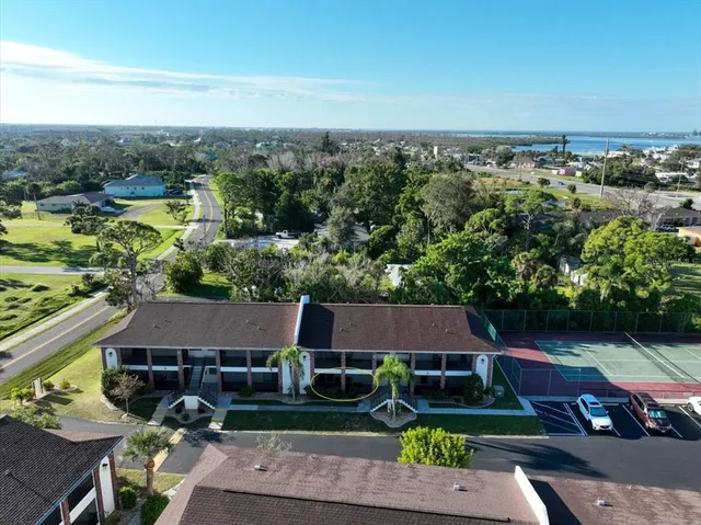 an aerial view of multiple houses with yard