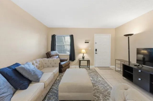 a bedroom with furniture and a flat screen tv