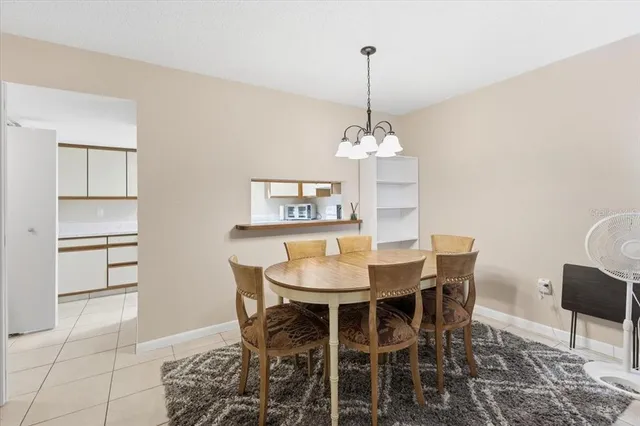 a view of a dining room with a table and chairs
