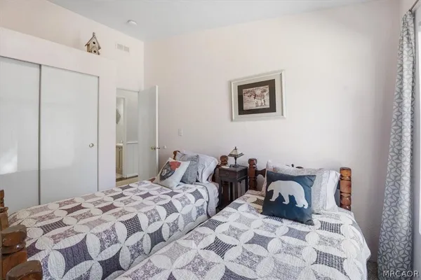a bedroom with a bed and a painting on the wall
