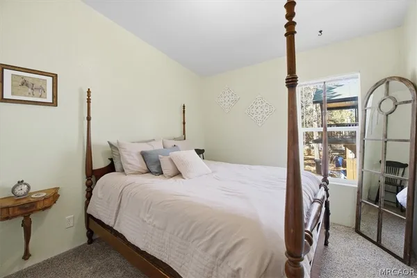 a bedroom with a bed couch and window