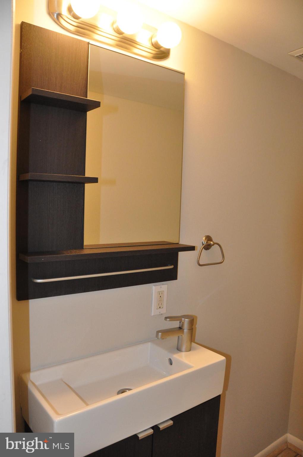 9705 Glen Avenue Silver Spring, MD 20910 - Photo 18 of 47 a bathroom with a sink and a mirror
