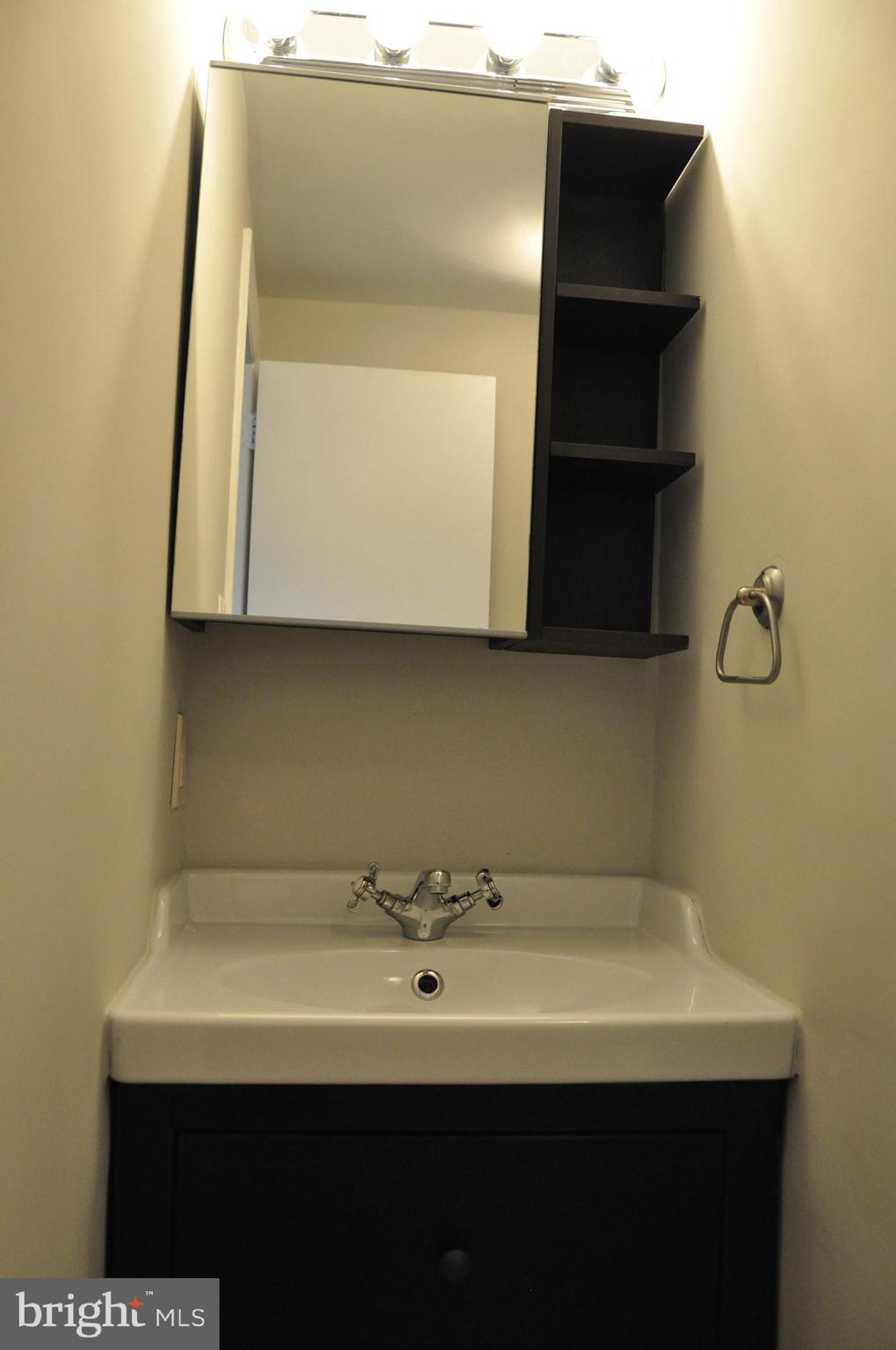 9705 Glen Avenue Silver Spring, MD 20910 - Photo 32 of 47 a bathroom with a sink and a mirror
