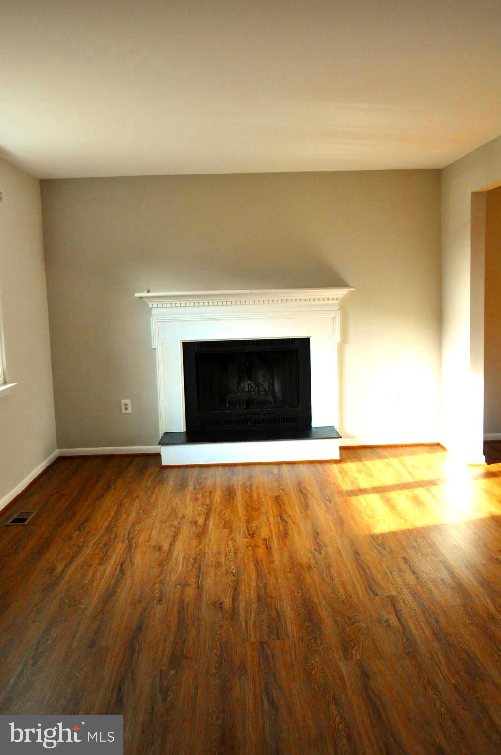 9705 Glen Avenue Silver Spring, MD 20910 - Photo 4 of 47 a view of empty room with wooden floor and a fireplace