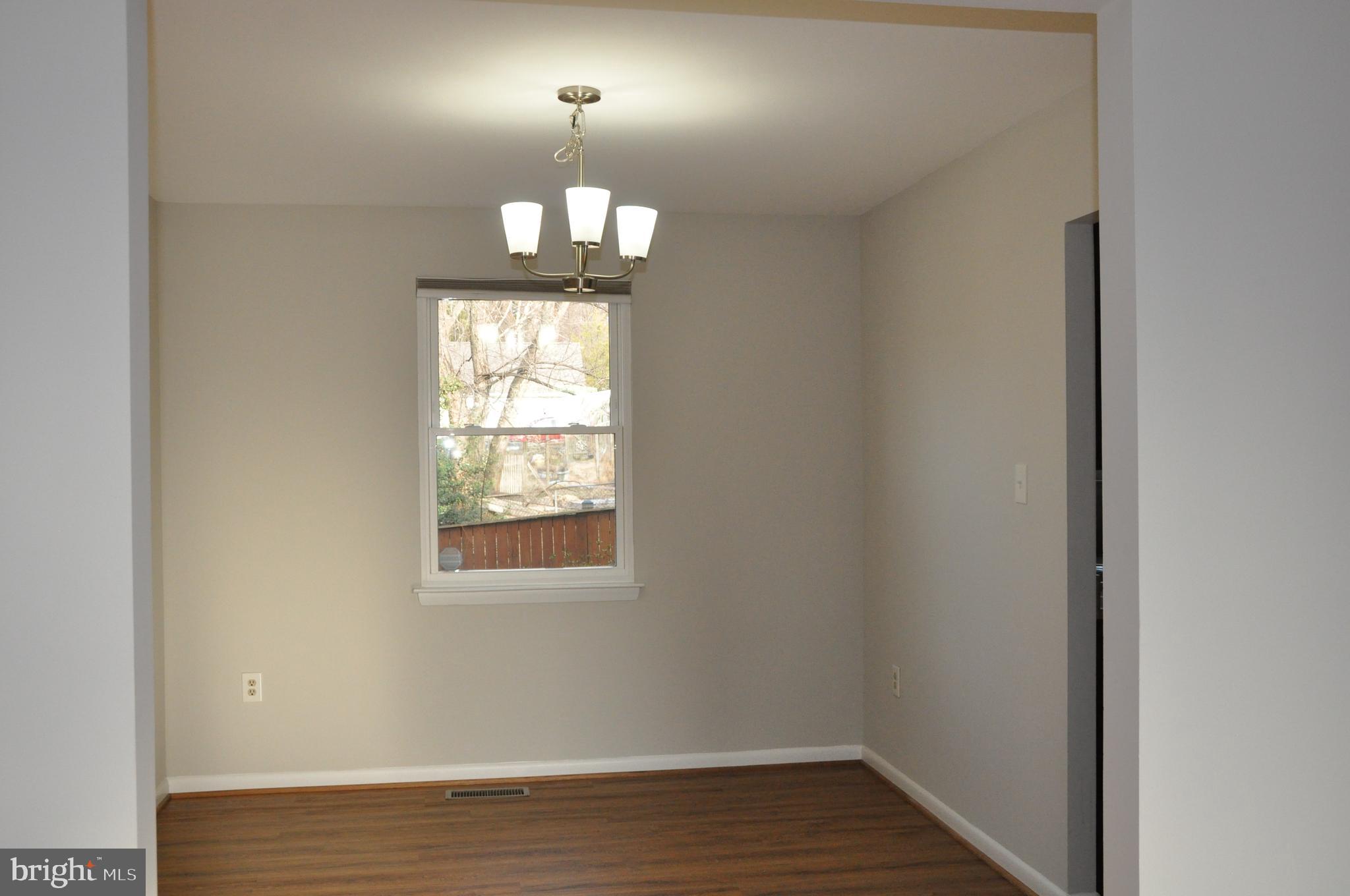 9705 Glen Avenue Silver Spring, MD 20910 - Photo 5 of 47 an empty room with wooden floor fan and window