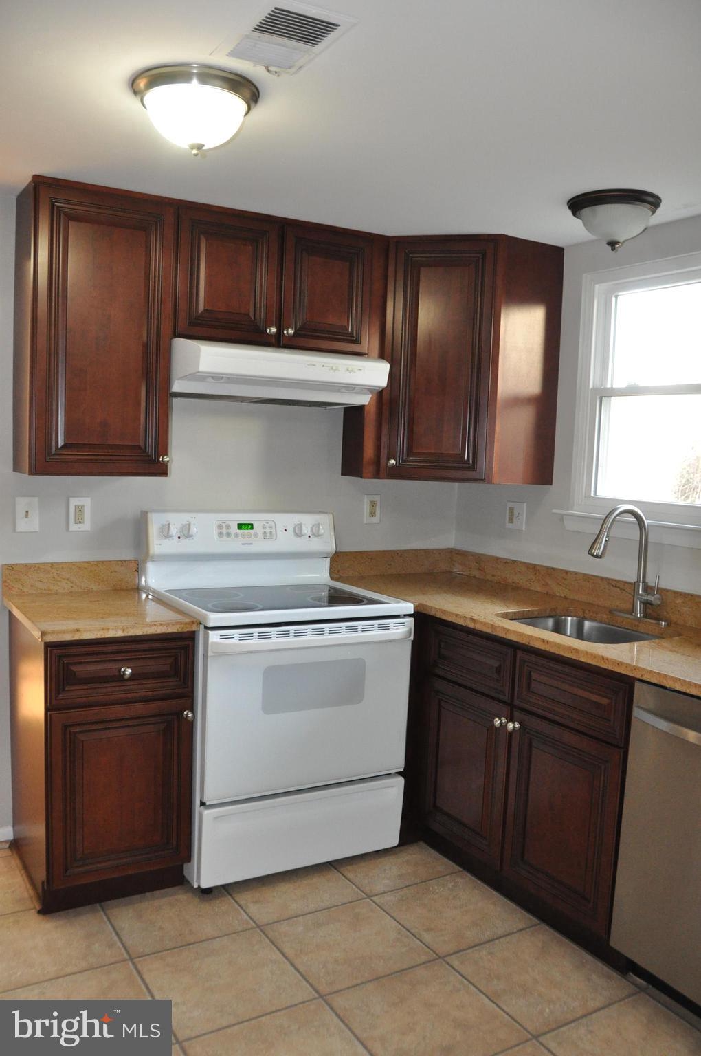 9705 Glen Avenue Silver Spring, MD 20910 - Photo 8 of 47 a kitchen with a stove sink and cabinets