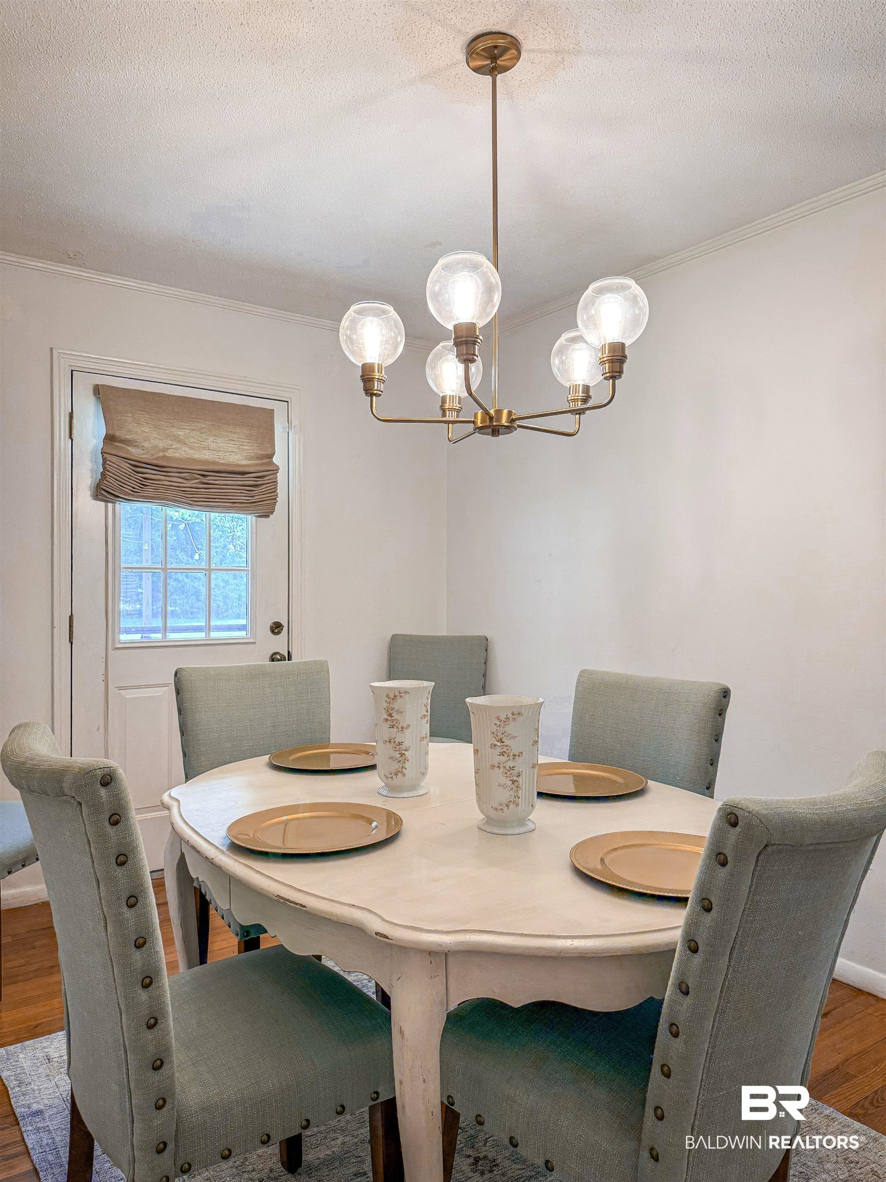 1508 Poplar Avenue Brewton, AL 36426 - Photo 6 of 22 Dining area with wood finished floors, a chandelier, a textured ceiling, and crown molding