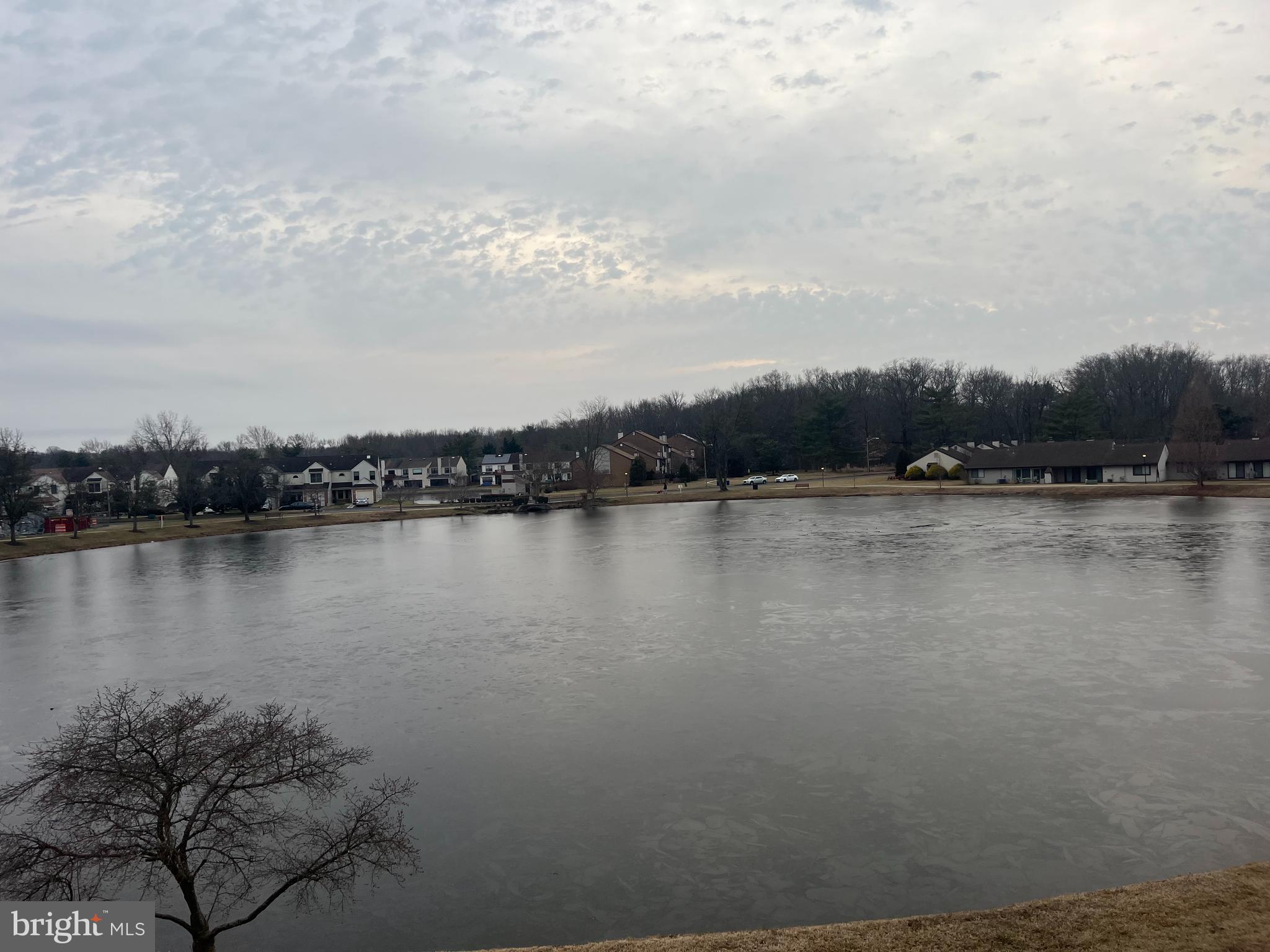 29 B East Daisy Lane Mount Laurel, NJ 08054 - Photo 5 of 14 a view of a lake with houses in the back