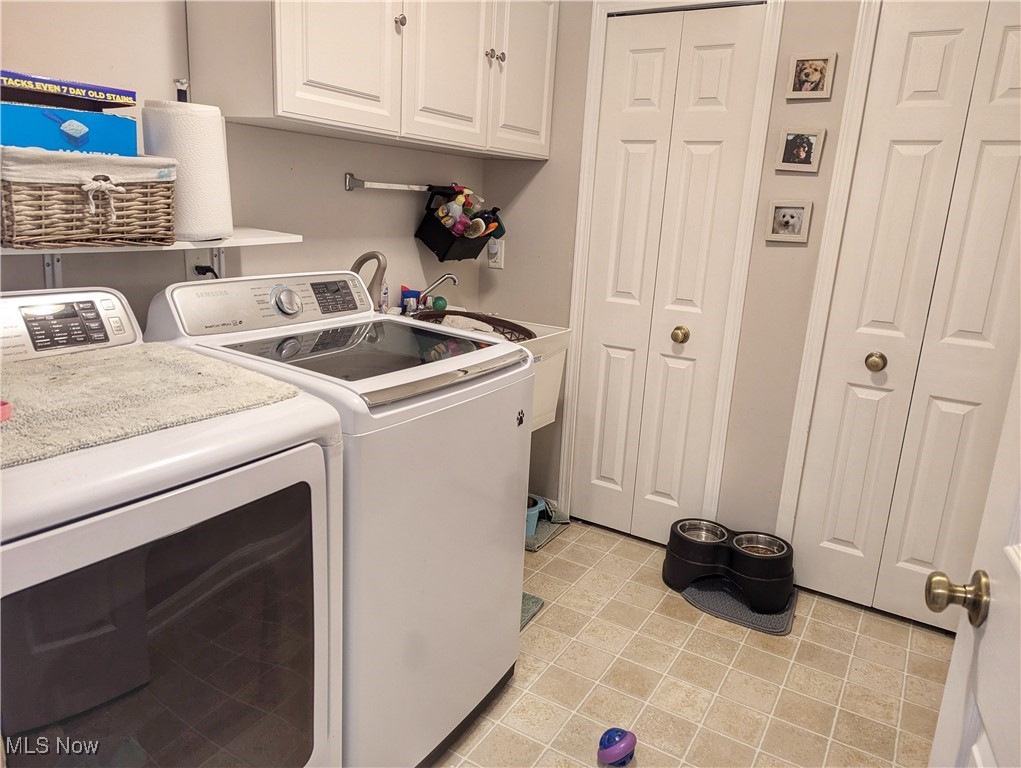 37625 Sandy Ridge Drive North Ridgeville, OH 44039 - Photo 37 of 44 Clothes washing area with light tile patterned floors, cabinets, and washer and dryer