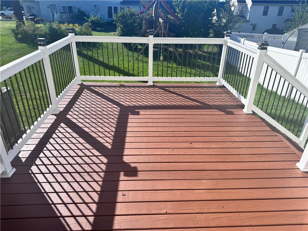 5494 Spring Ridge Drive West Macungie, PA 18062 - Photo 15 of 20 An elevated wood deck with white railings overlooks a grassy backyard.