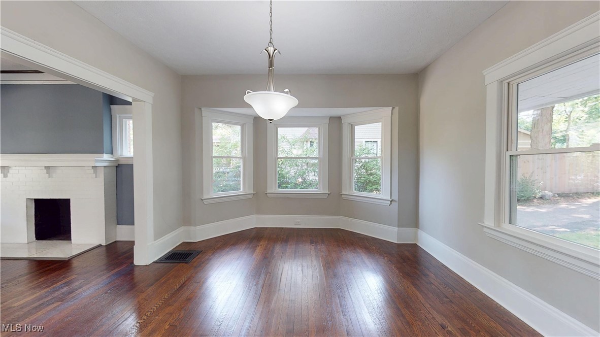 3174 Oak Road Cleveland, OH 44118 - Photo 13 of 33 Unfurnished dining area with plenty of natural light, wood finished floors, and a brick fireplace