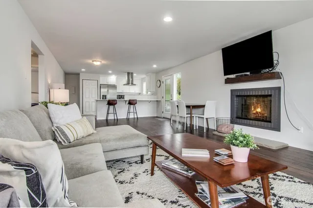 a living room with fireplace furniture and a flat screen tv
