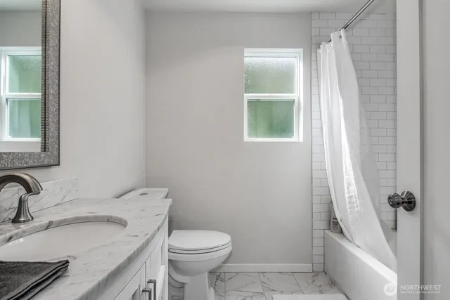 a bathroom with a sink toilet and tub