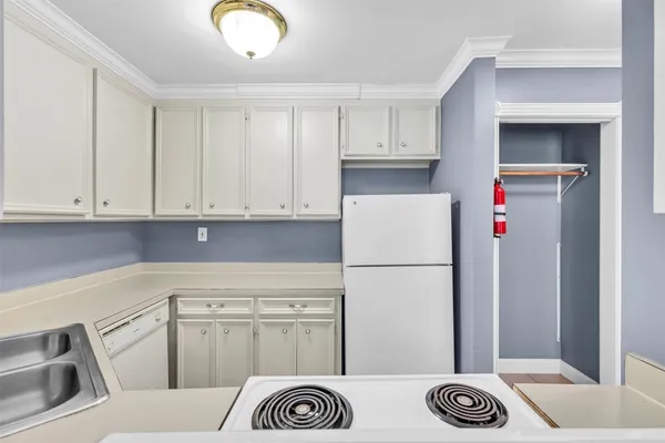 a kitchen with a stove and a refrigerator