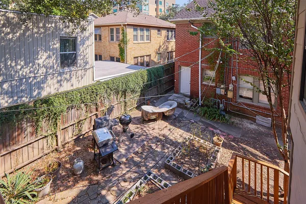 a view of a chairs and table in the backyard