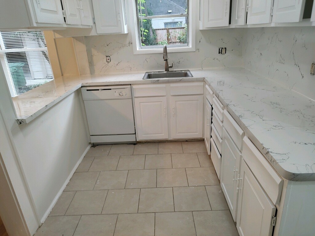 2634 Peckham Street Houston, TX 77098 - Photo 4 of 9 a kitchen with a sink a stove cabinets and a window