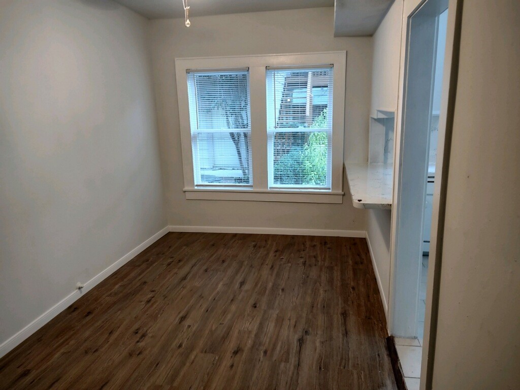 2634 Peckham Street Houston, TX 77098 - Photo 6 of 9 an empty room with wooden floor and windows