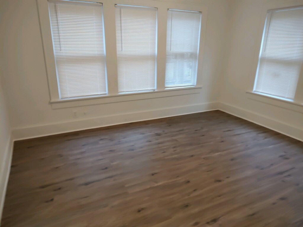 2634 Peckham Street Houston, TX 77098 - Photo 8 of 9 an empty room with wooden floor and windows