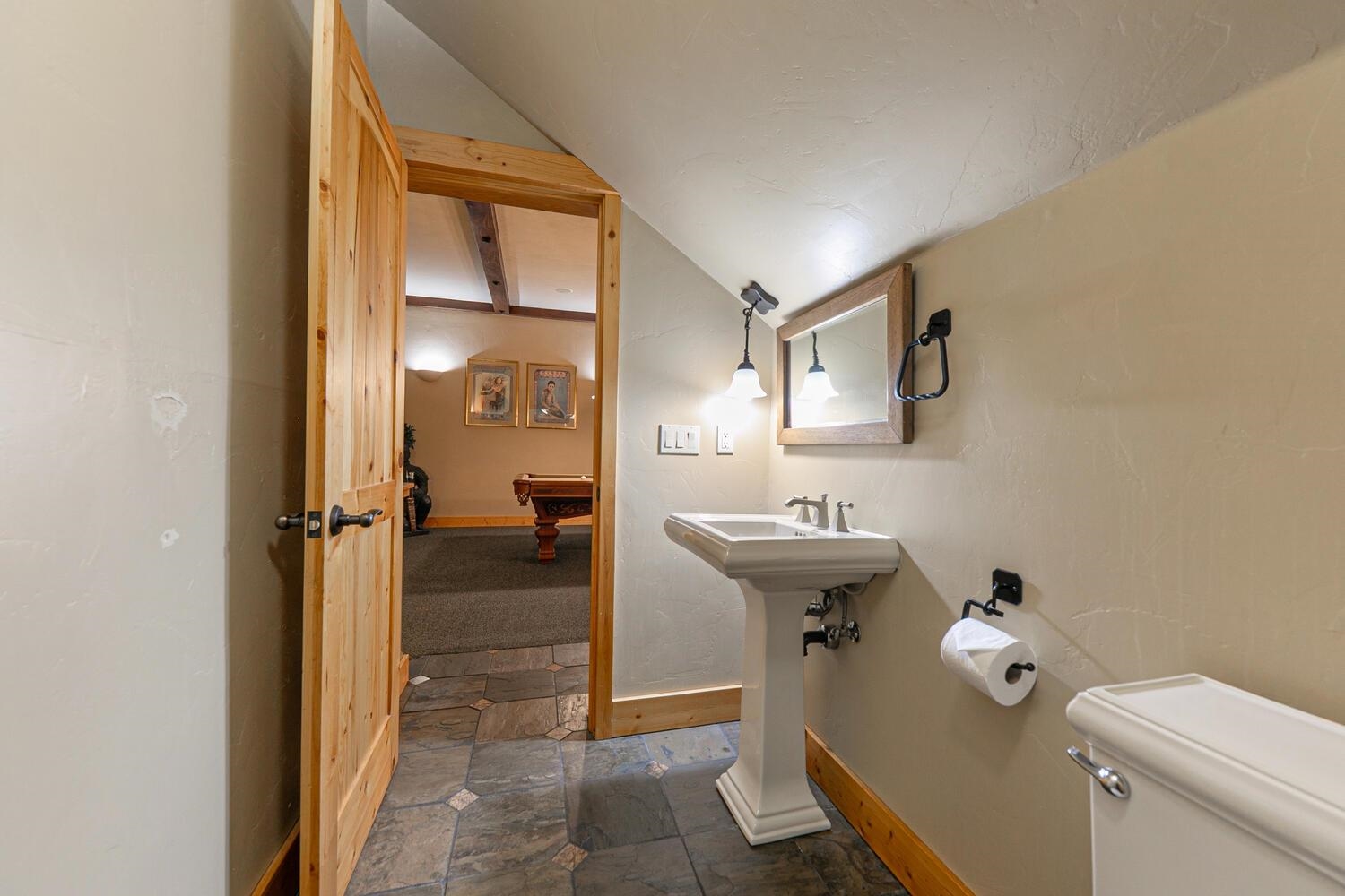 14070 Alder Creek Road Truckee, CA 96161 - Photo 16 of 28 a bathroom with a sink a toilet and shower