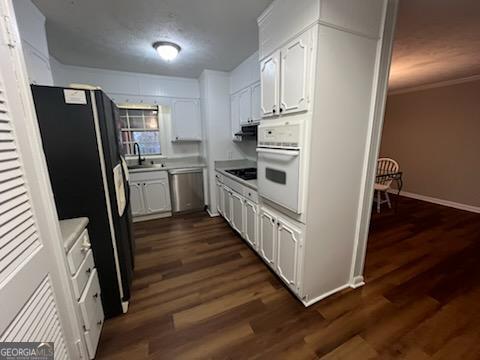 809 College Street Carrollton, GA 30117 - Photo 11 of 33 a kitchen with white cabinets and stainless steel appliances