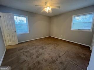 809 College Street Carrollton, GA 30117 - Photo 13 of 33 an empty room with windows and fan