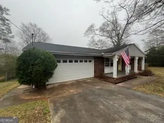 a view of a house with a yard and garage