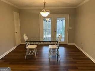a dining room with wooden floor a chandelier a glass table and chairs