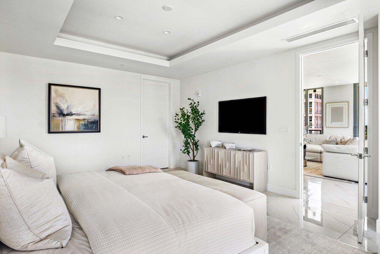 495 East Royal Palm Road, Unit 601 Boca Raton, FL 33432 - Photo 16 of 50 a bedroom with a bed tv on the wall and a window