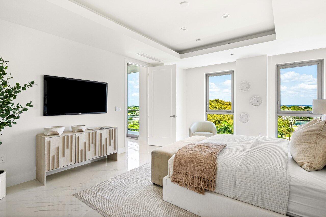 495 East Royal Palm Road, Unit 601 Boca Raton, FL 33432 - Photo 17 of 50 a bedroom with a flat screen tv bed and a flat tv screen on dresser