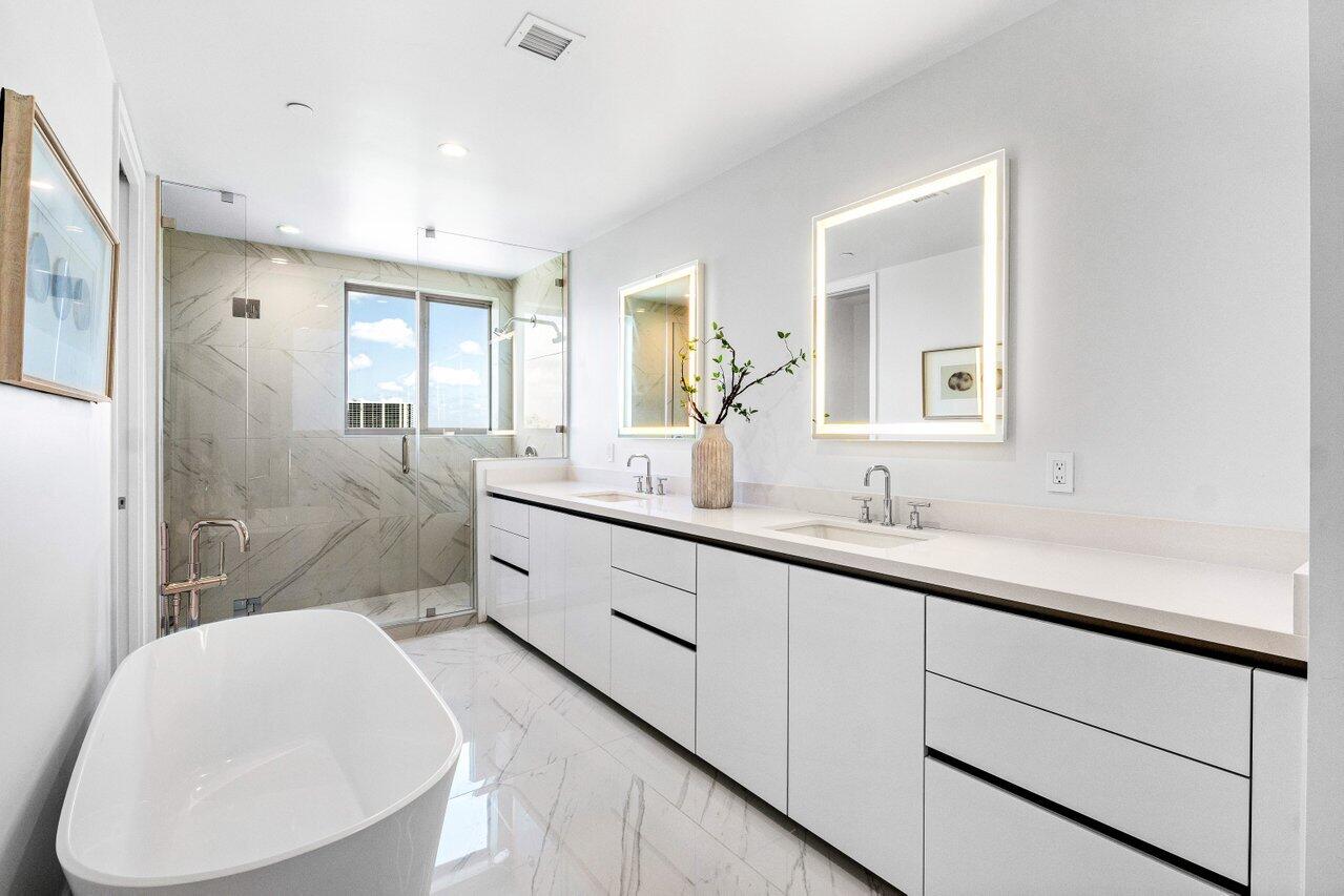 495 East Royal Palm Road, Unit 601 Boca Raton, FL 33432 - Photo 19 of 50 a bathroom with a double vanity sink toilet mirror and bathtub