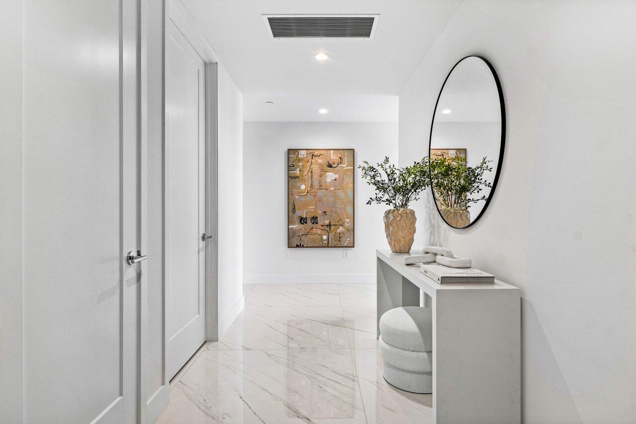 495 East Royal Palm Road, Unit 601 Boca Raton, FL 33432 - Photo 2 of 50 a view of a hallway with paintings on the wall