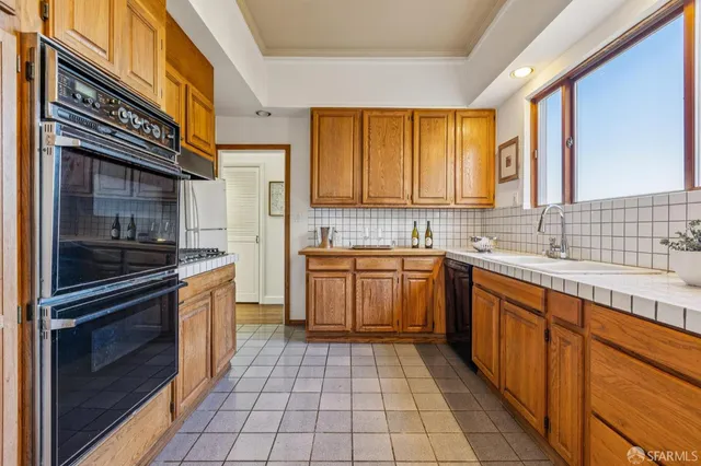 a kitchen with a sink and a stove top oven