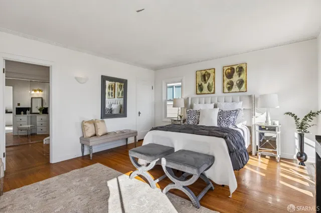 a living room with furniture a fireplace and a potted plant