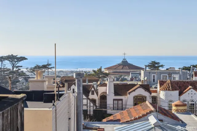 a front view of a residential apartment building with a city view