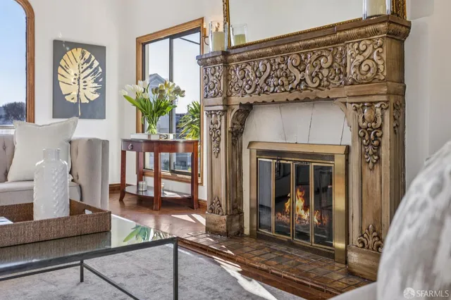 a living room with fireplace furniture and a window