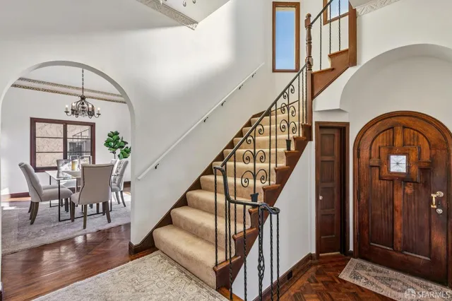 a view of a dining room with furniture wooden floor and chandelier