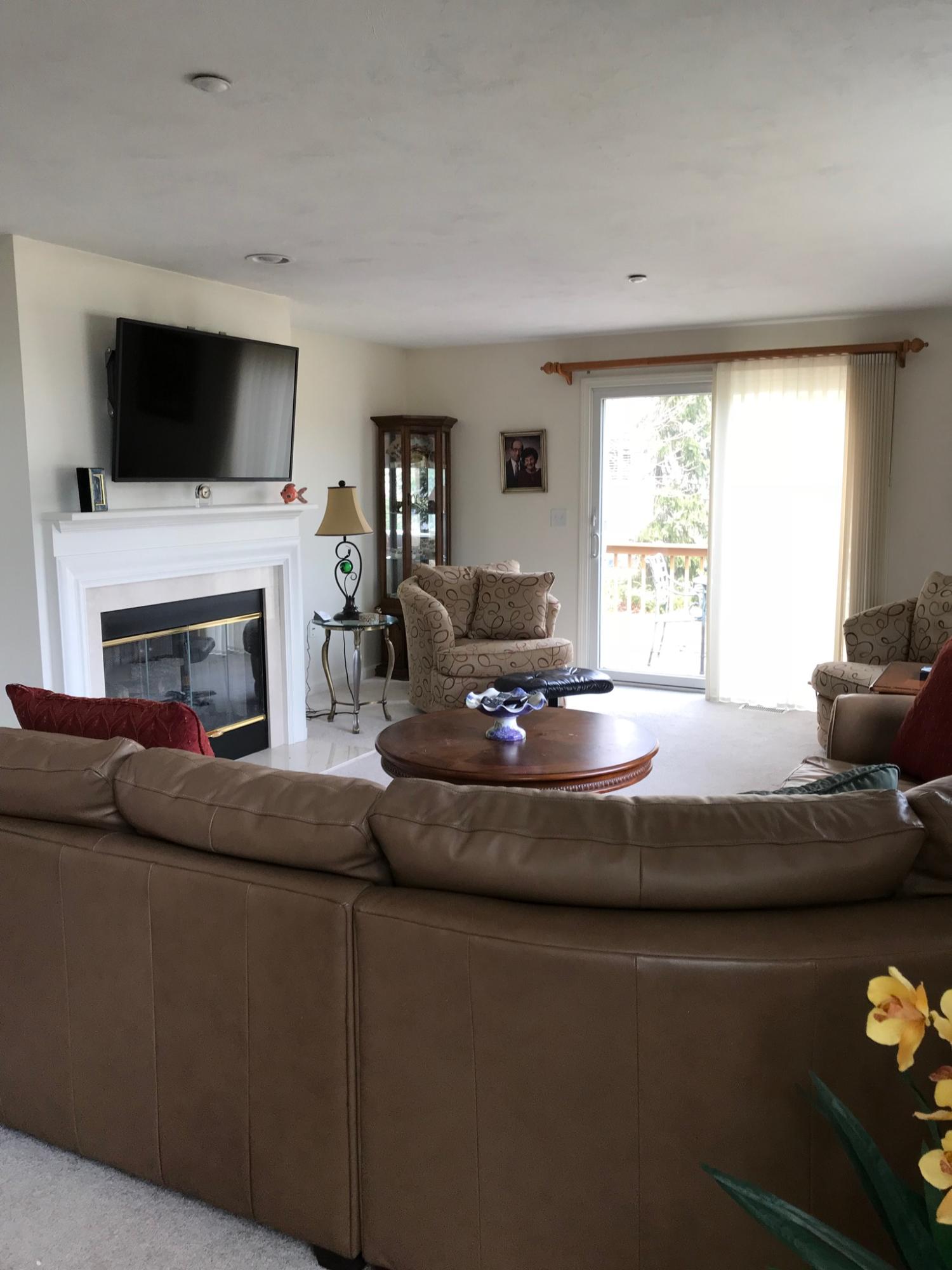 a living room with fireplace furniture and a flat screen tv
