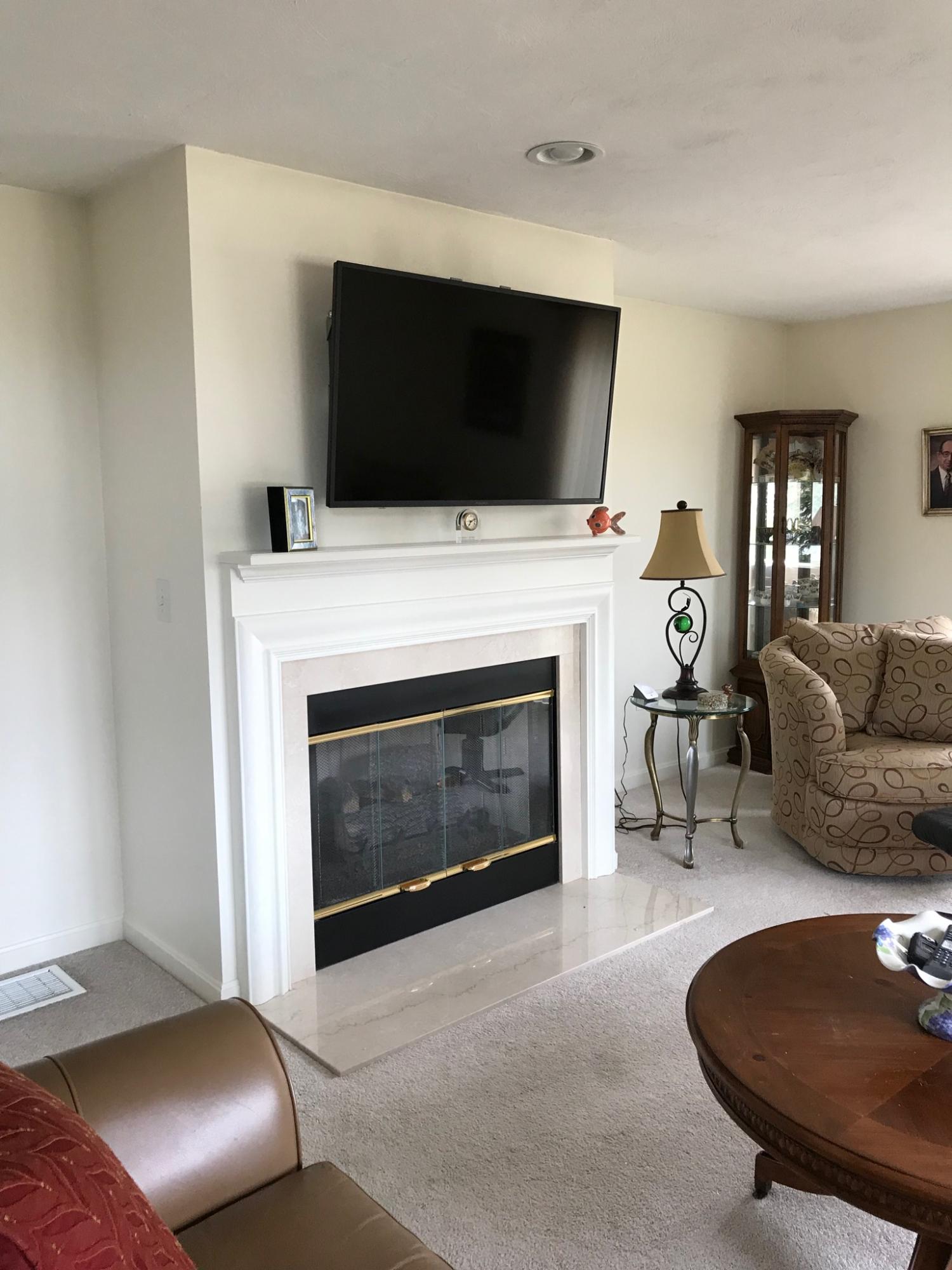 1 North Ridge Road Mashpee, MA 02649 - Photo 14 of 34 a living room with furniture a flat screen tv and a fireplace