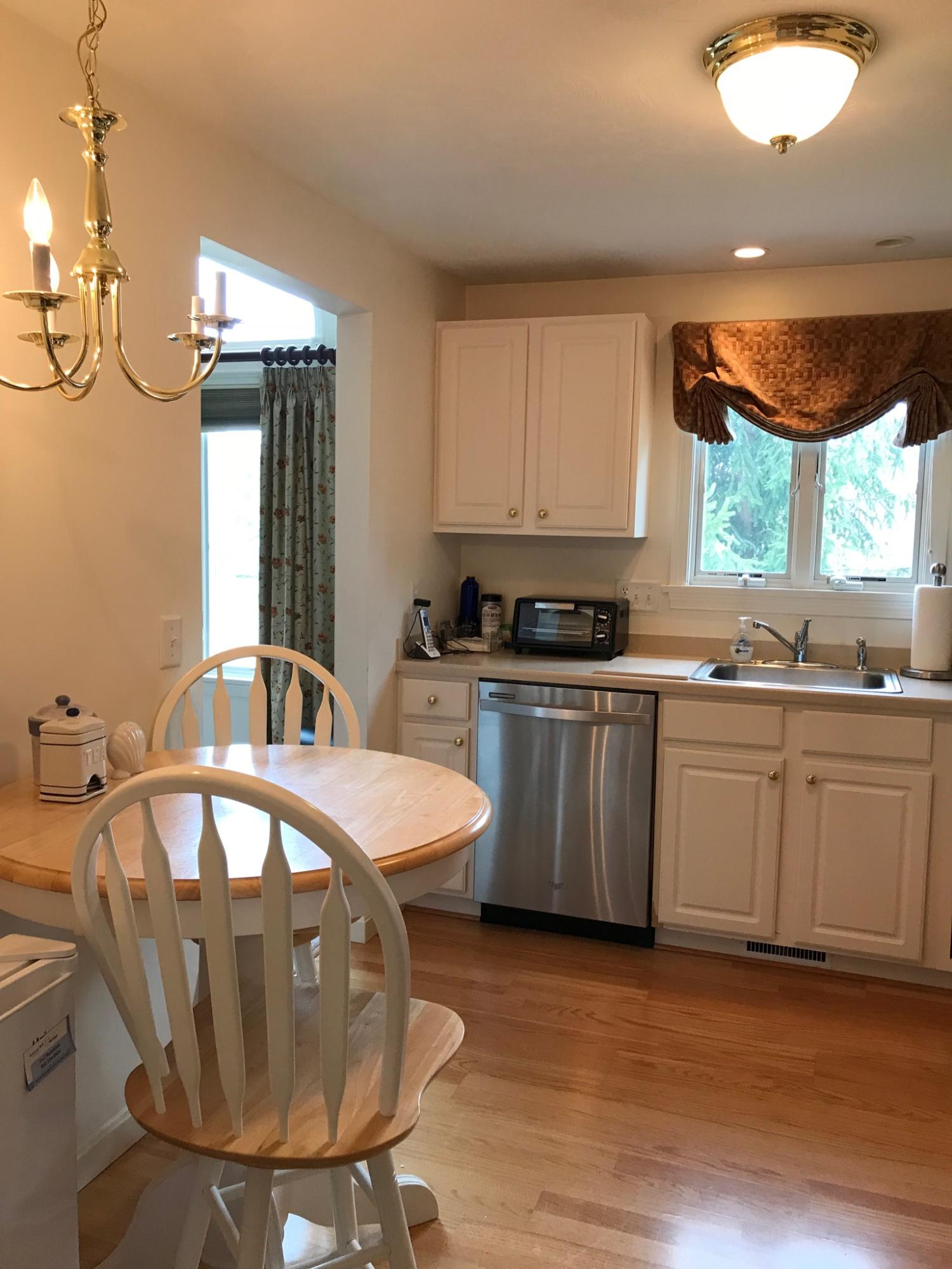 1 North Ridge Road Mashpee, MA 02649 - Photo 4 of 34 a kitchen with stainless steel appliances granite countertop a sink a stove a table and chairs