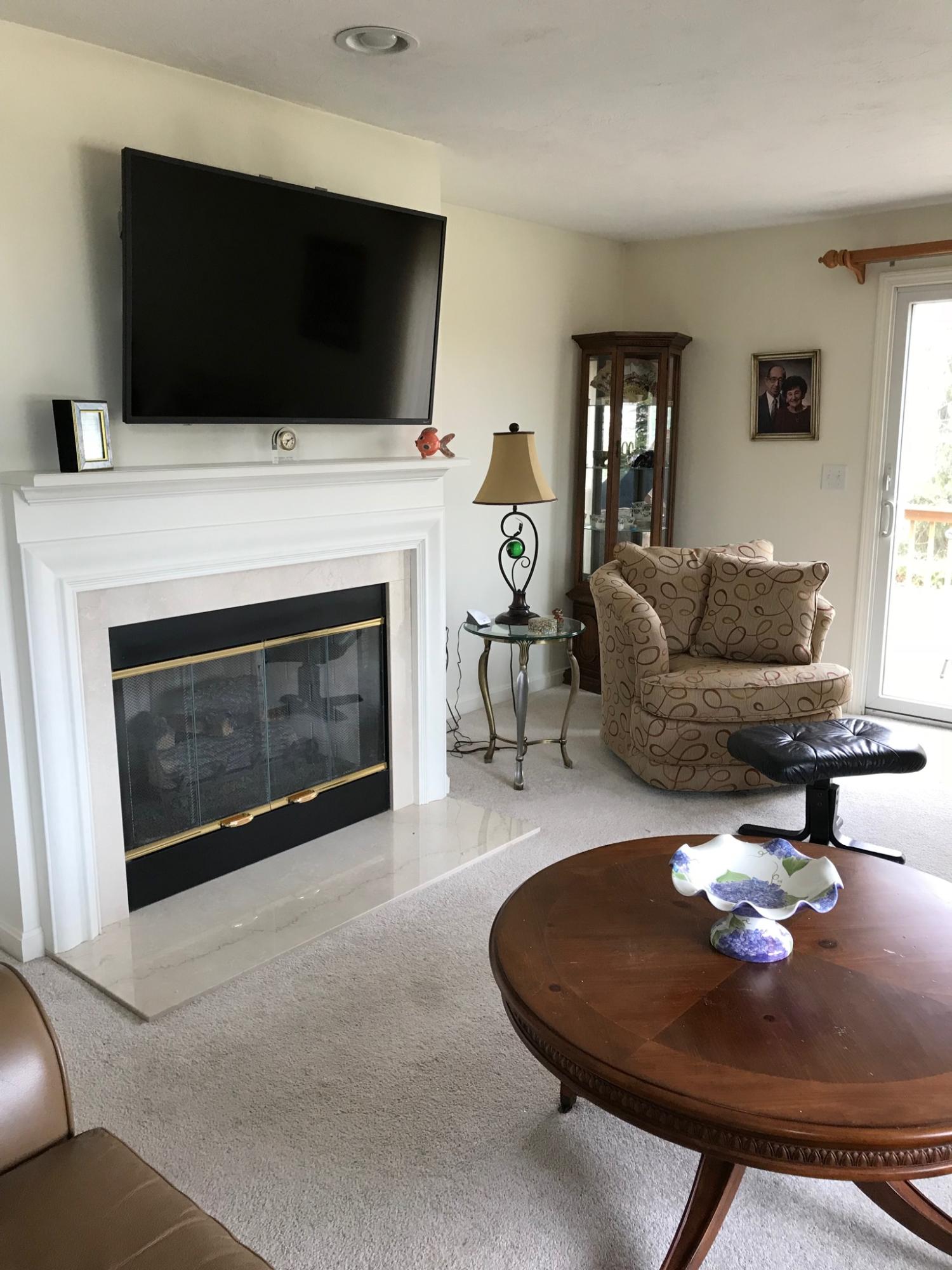 1 North Ridge Road Mashpee, MA 02649 - Photo 10 of 34 a living room with furniture a flat screen tv and a fireplace