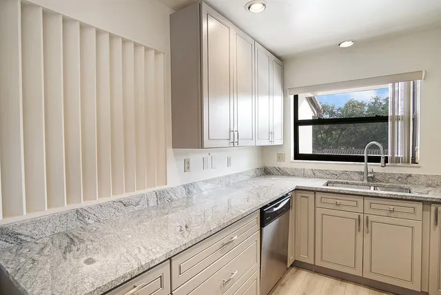 a kitchen with a sink and cabinets
