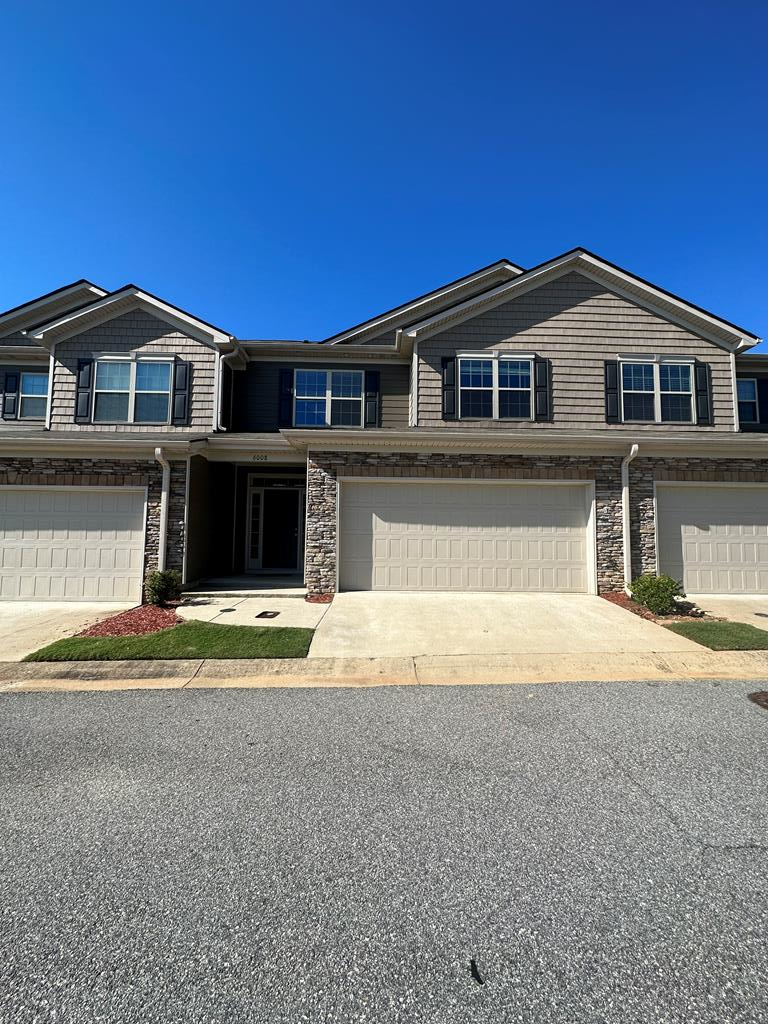 6008 Townes Way Columbus, GA 31909 - Photo 1 of 22 a front view of a house with a yard and garage