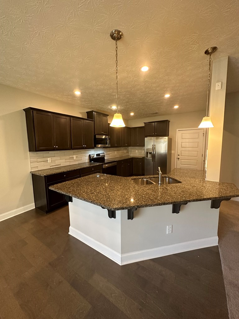 6008 Townes Way Columbus, GA 31909 - Photo 11 of 22 a large white kitchen with a large island oven a stove with wooden floor