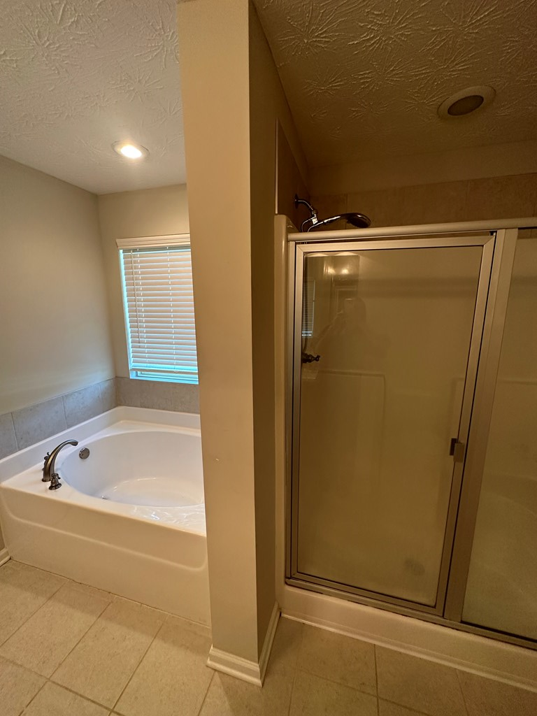 6008 Townes Way Columbus, GA 31909 - Photo 15 of 22 a bathroom with a tub and shower