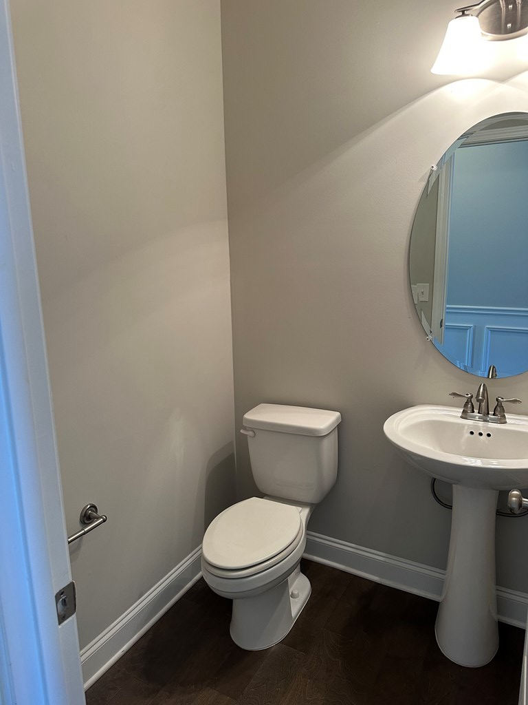 6008 Townes Way Columbus, GA 31909 - Photo 4 of 22 a white toilet sitting next to a bathroom sink