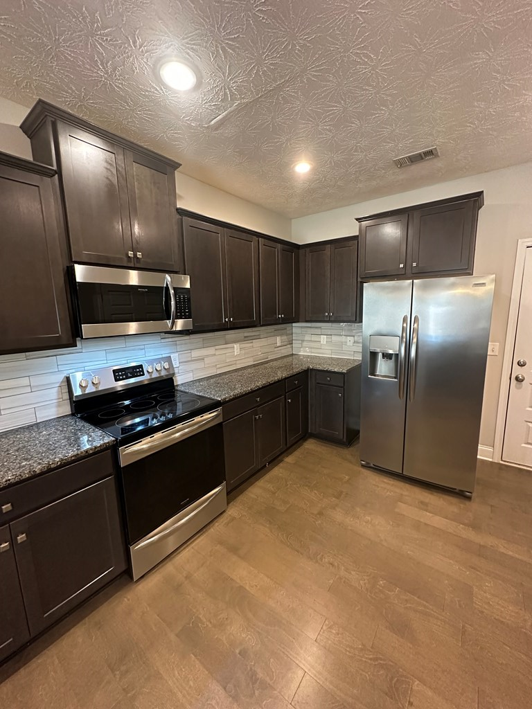 6008 Townes Way Columbus, GA 31909 - Photo 9 of 22 a large kitchen with cabinets and stainless steel appliances