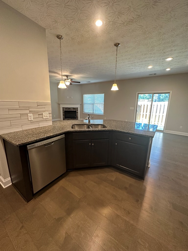 6008 Townes Way Columbus, GA 31909 - Photo 10 of 22 a kitchen with stainless steel appliances granite countertop a sink a stove and a wooden floors