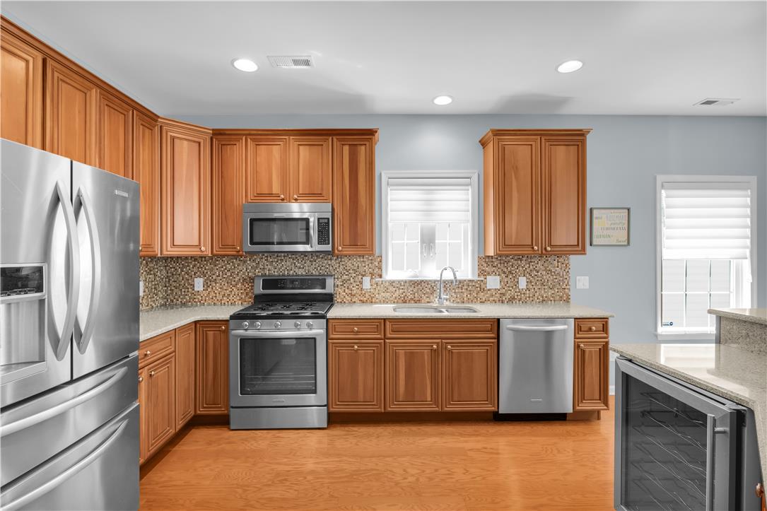 1011 Resolution Drive Bethlehem, PA 18017 - Photo 14 of 49 a kitchen with stainless steel appliances granite countertop a stove a sink dishwasher a refrigerator and a microwave oven