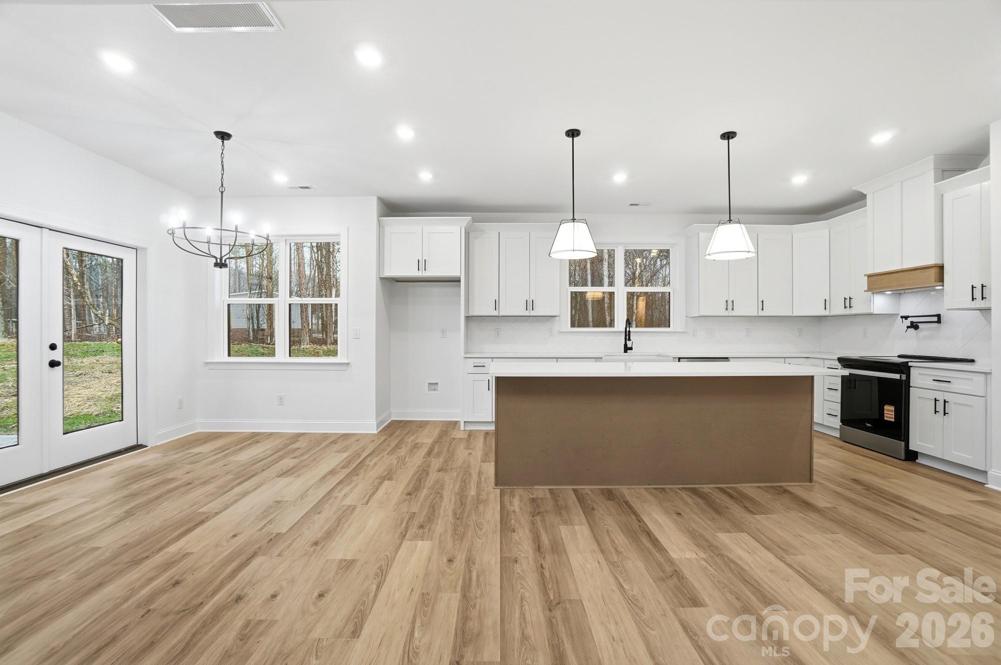 240 Hephzibah Church Road Crouse, NC 28033 - Photo 12 of 48 a large kitchen with kitchen island a sink stainless steel appliances and cabinets