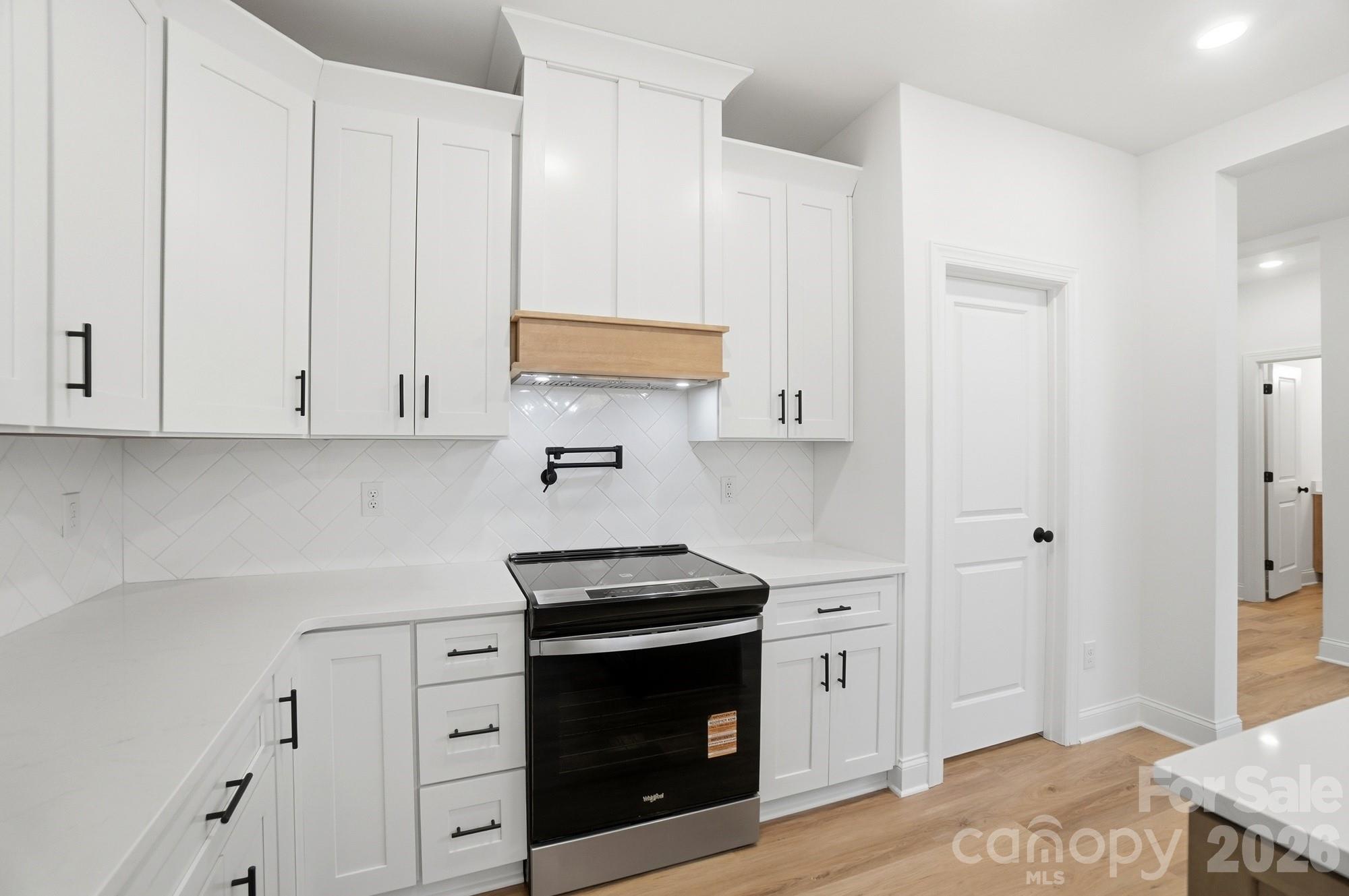 240 Hephzibah Church Road Crouse, NC 28033 - Photo 17 of 48 a kitchen with stainless steel appliances white cabinets and a sink